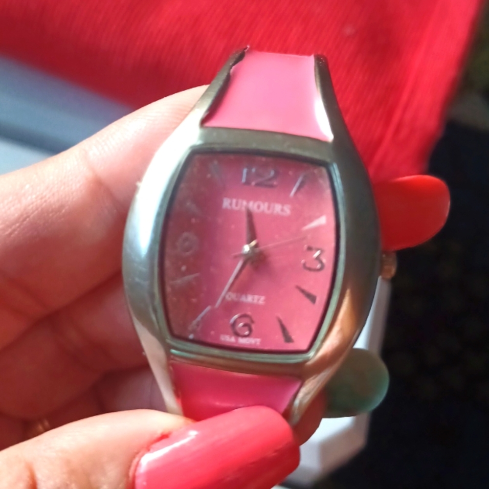 Women's watch in hot pink and silver. Bracelet type of band.
